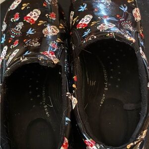 Skull slip on clogs.